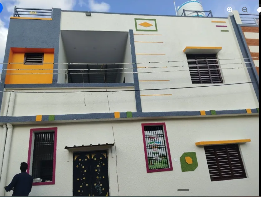 Two-level grey and white home with orange, magenta, yellow and green facade accents.