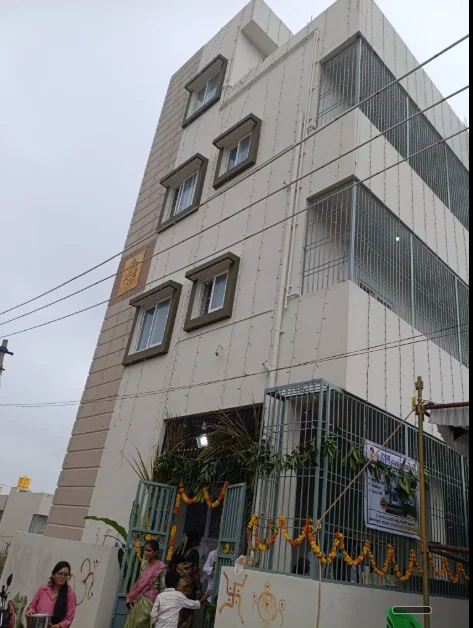 Tall multi-storey corner residence with stacked windows and screened upper-level edges.
