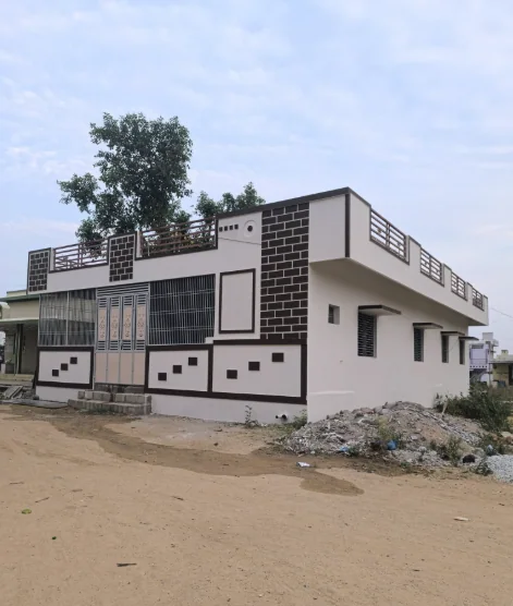 Low-rise corner home with black-and-white patterned facade panels and a roof terrace.