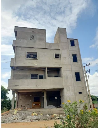 Multi-storey residential building under construction by KSR House Contractors with exterior plastering in progress
